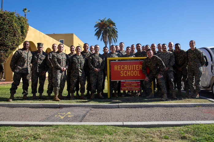 Sgt. Maj. Carlos Ruiz, the 20th Sergeant Major of the Marine Corps, poses for a photo with basic recruiters school staff at Marine Corps Recruit Depot San Diego, Dec. 5, 2023. Ruiz visited the Depot to listen to the ideas, questions, and concerns of Marines throughout the installation on how to improve the Marine Corps and recruiting mission. (U.S. Marine Corps photo by Lance Cpl. Sarah M. Grawcock)