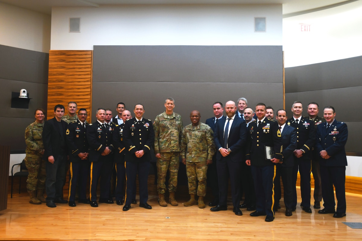 Army Gen. Daniel Hokanson, chief of the National Guard Bureau, and Senior Enlisted Advisor Tony Whitehead, SEA to the CNGB, center left and center right, respectively, with competitors of the 2023 National Guard Bureau Innovation Challenge at the Herbert R. Temple Jr. Army National Guard Readiness Center, Arlington Hall Station, Virginia, Dec. 7, 2023. Arizona Army National Guard members took home top honors for their concept of exportable maneuver live-fire capabilities that could help units achieve training requirements.