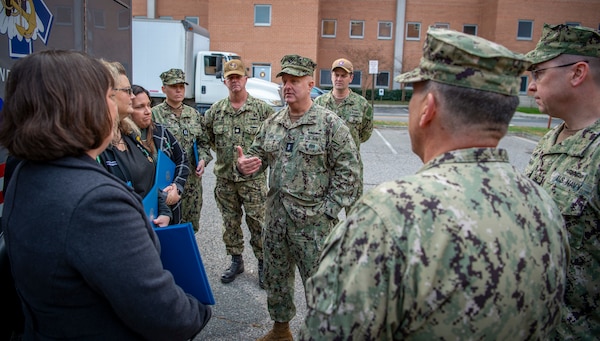 Surgeon General of the Navy Rear Adm. Darin Via, center, speaks with members from Naval Medical Center Portsmouth’s (NMCP) trauma team following a trauma center ribbon cutting ceremony in front of NMCP’s emergency room entrance on Dec. 8.