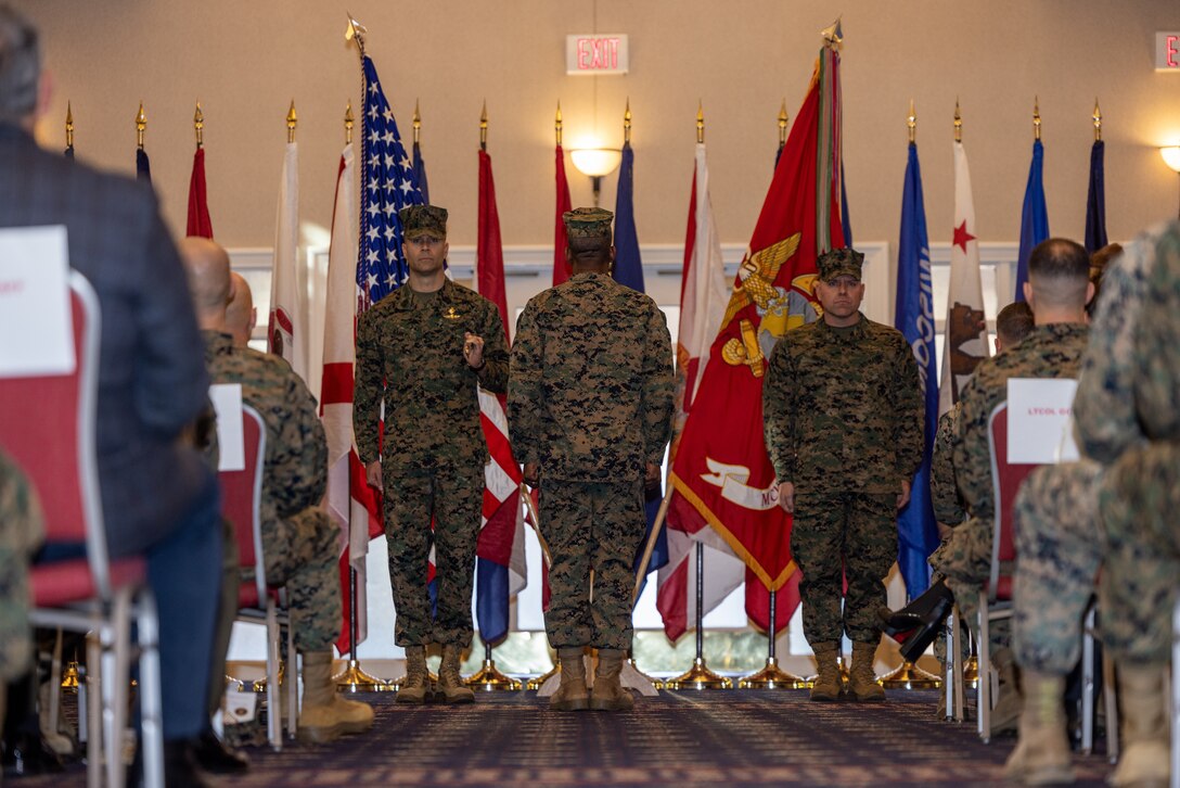 U.S. Marine Corps Sgt. Maj. Collin D. Barry, outgoing sergeant major, Marine Corps Base Quantico, native of Tucumcari, New Mexico, left, Col. Michael L. Brooks, base commander, MCBQ, native of South Boston, Virginia, and Sgt. Maj. Michael R. Brown, oncoming base sergeant major, MCBQ, native of Jacksonville, Florida, stand at attention during Barry’s relief and appointment ceremony at The Clubs at Quantico, MCBQ, Virginia, Dec. 8, 2023. U.S. Marines, family and others gathered to witness Barry retire and transfer the duties onto Brown as the new sergeant major of MCBQ. (U.S. Marine Corps photo by Lance Cpl. Joaquin Dela Torre)