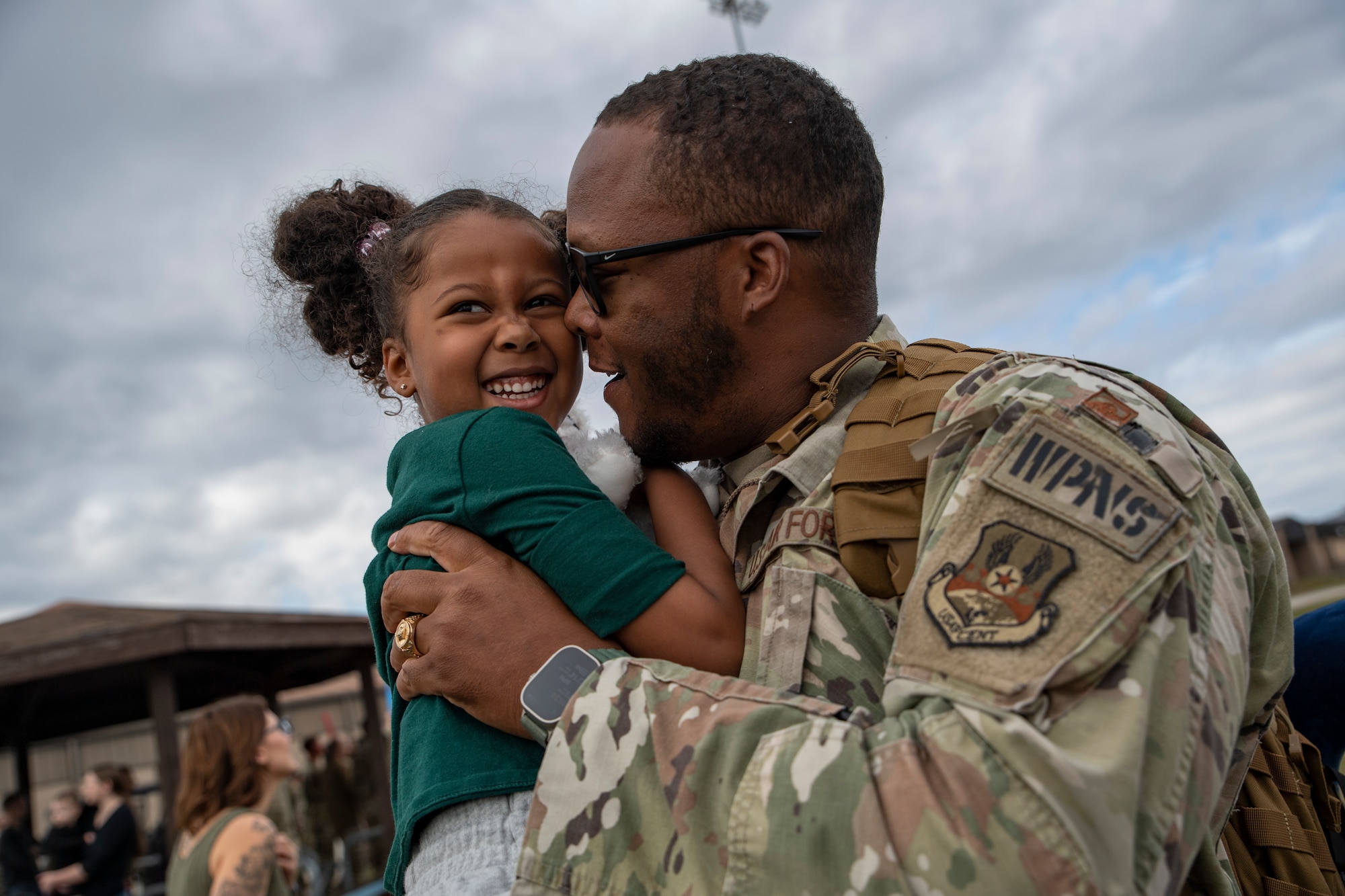 An Airman hugs his daughter