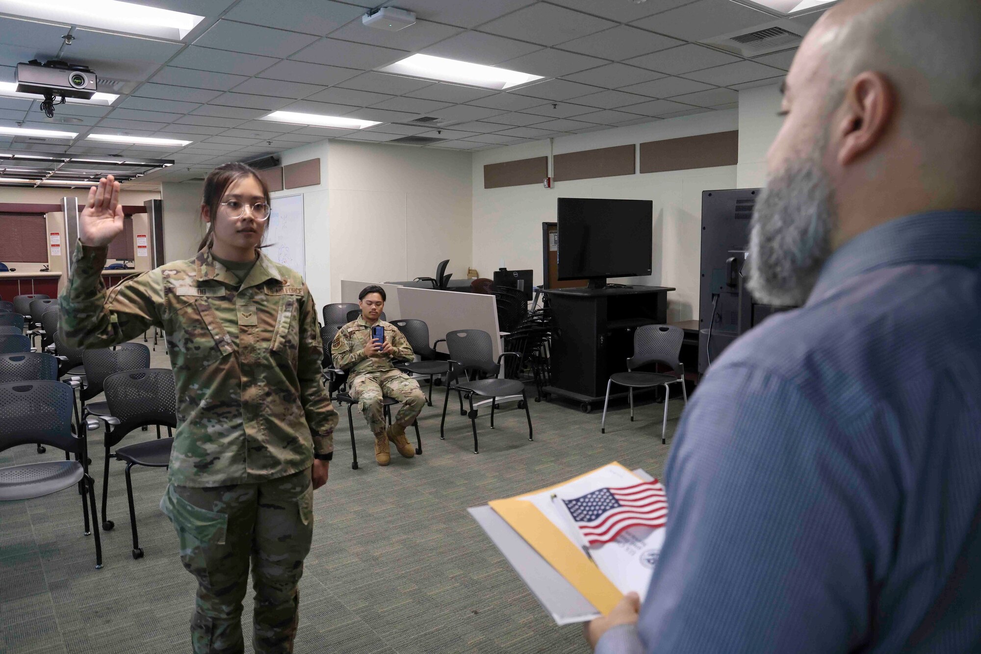 U.S. Air Force Airman 1st Class Trieu Do, 9th Force Support Squadron food service specialist, recites the Oath of Allegiance during a naturalization ceremony at the United States Citizenship and Immigration Services field office in Sacramento, California, Nov. 15, 2023.