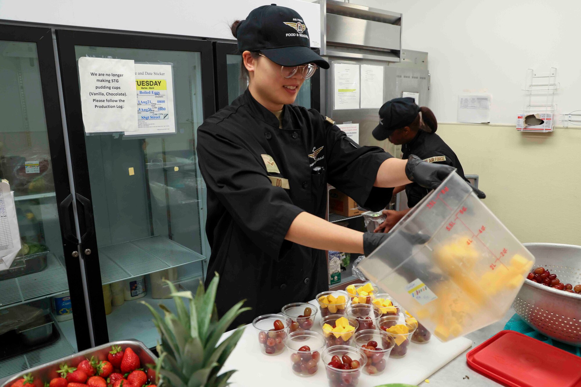 U.S. Air Force Airman 1st Class Trieu Do, 9th Force Support Squadron food service specialist, prepares cheese and fruit cups at the Contrails Dining Facility on Beale Air Force Base, California, Nov. 17, 2023.