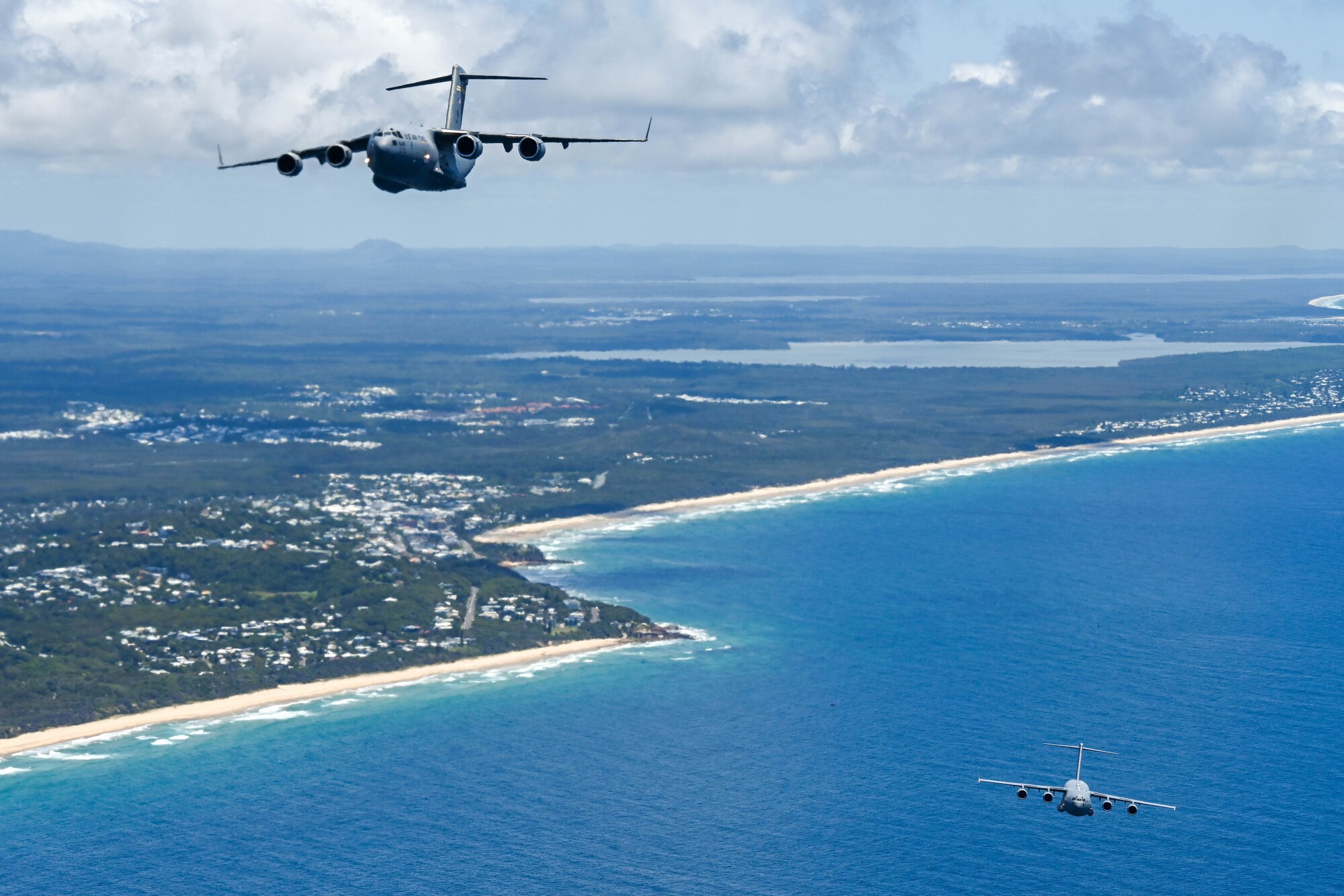 U.S. Air Force and Royal Air Force C-17 Globemaster IIIs participate in a  training flight during Exercise Global Dexterity 23-2 in the skies of Australia, Dec. 8, 2023. Exercise Global Dexterity prepares our air forces for combined action in wartime, peacetime and humanitarian operations throughout the Indo-Pacific. (U.S. Air Force photo by Senior Airman Makensie Cooper)