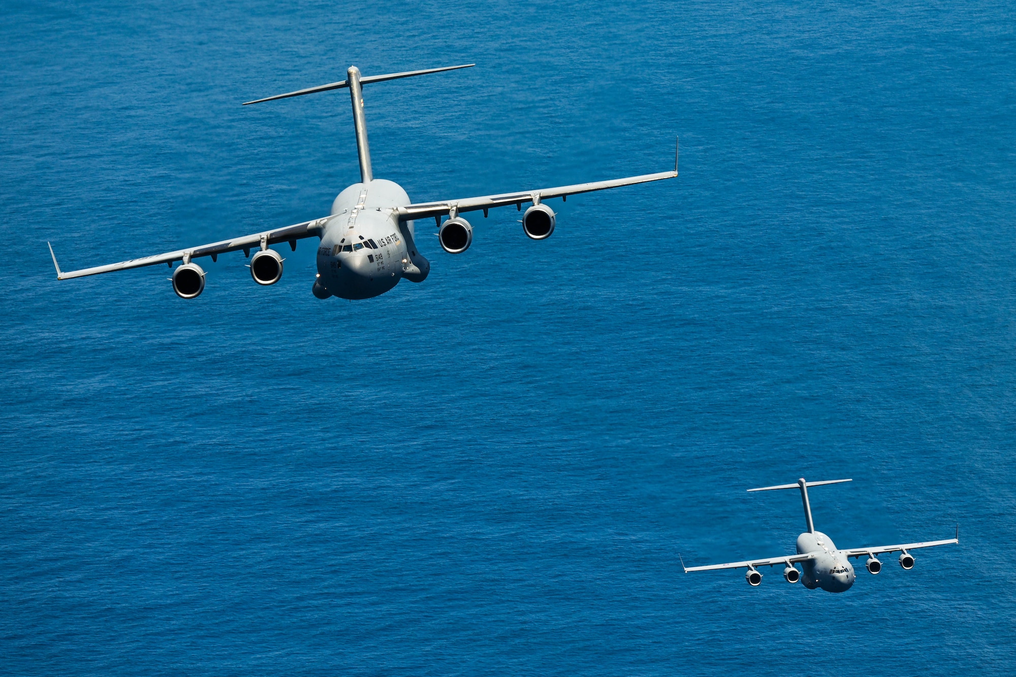 U.S. Air Force and Royal Air Force C-17 Globemaster IIIs take part in a training flight during Exercise Global Dexterity 23-2 in the skies of Australia, Dec. 8, 2023. Exercise Global Dexterity prepares our air forces for combined action in wartime, peacetime and humanitarian operations throughout the Indo-Pacific. (U.S. Air Force photo by Senior Airman Makensie Cooper)