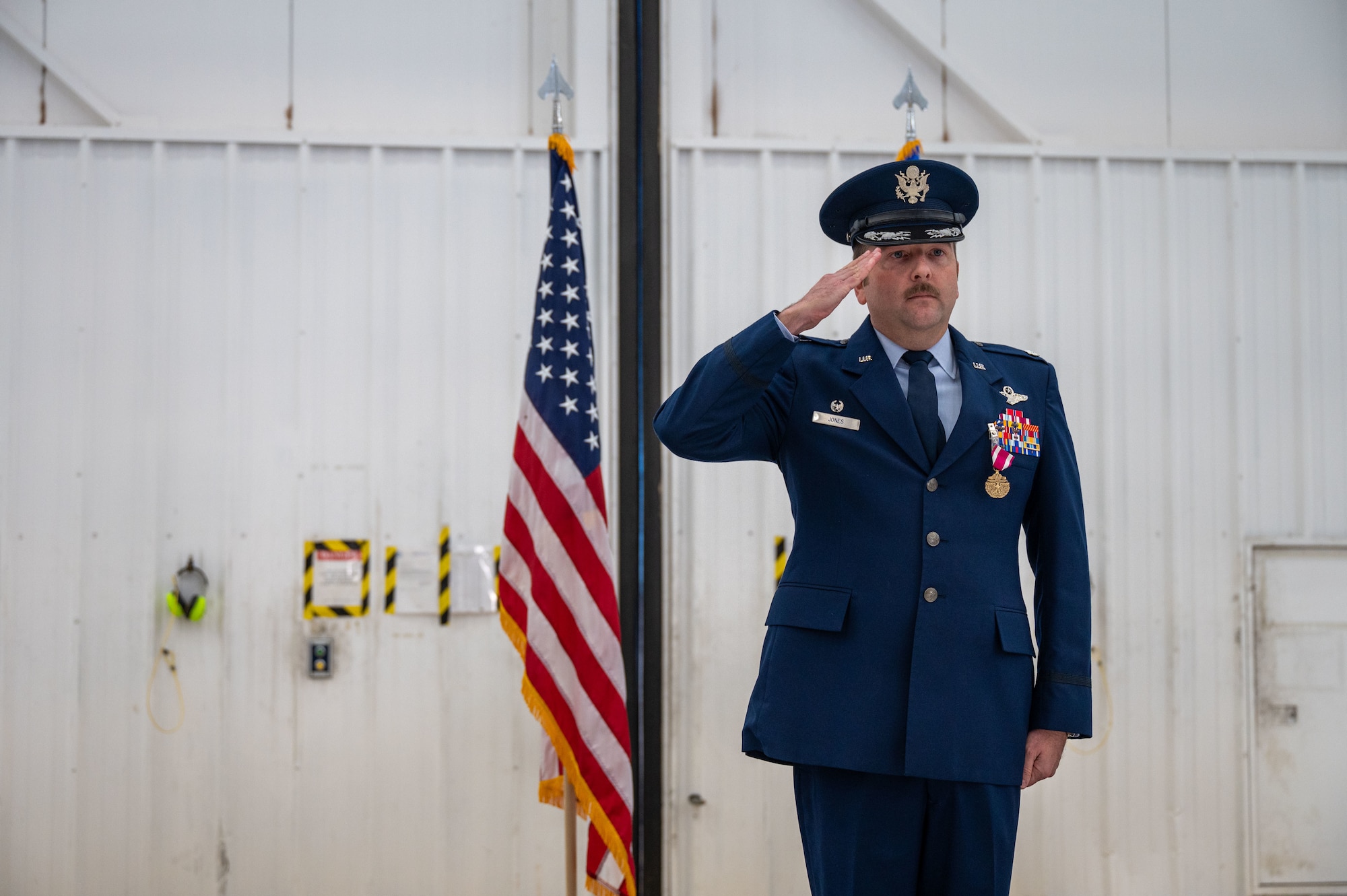 U.S. Air Force Lt. Col. Adam Jones, 27th Special Operations Air Operations Squadron outgoing commander, gives the final salute to the 27 SOAS during the redesignation ceremony on Dec. 8, 2023, at Cannon Air Force Base, N.M. During the ceremony, the 27th Special Operations Air Operation Squadron was redesignated as the 27th Special Operations Theater Air Operation Squadron marking the end of the SOAS’ mission for a new a framework that aligns with the Air Force Special Operations Theater Engagement Construct. (U.S. Air Force photo by Senior Airman Alexcia Givens)