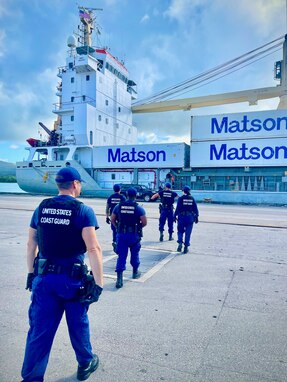 A U.S. Coast Guard Sector Boarding Team, a key component of U.S. Coast Guard Forces Micronesia/Sector Guam, conducts a thorough security boarding of the 380-foot (116-meter) motor vessel Papa Mau, flagged from Antigua Barbuda, at the Port of Guam on Dec. 6, 2023. This general cargo vessel, arriving from Pohnpei in the Federated States of Micronesia (FSM), was meticulously inspected upon reaching Guam and found to be in full compliance. (U.S. Coast Guard photo by Lt. Brian Maffucci)