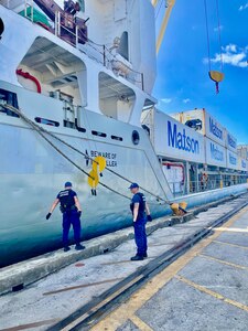 A U.S. Coast Guard Sector Boarding Team, a key component of U.S. Coast Guard Forces Micronesia/Sector Guam, conducts a thorough security boarding of the 380-foot (116-meter) motor vessel Papa Mau, flagged from Antigua Barbuda, at the Port of Guam on Dec. 6, 2023. This general cargo vessel, arriving from Pohnpei in the Federated States of Micronesia (FSM), was meticulously inspected upon reaching Guam and found to be in full compliance. (U.S. Coast Guard photo by Lt. Brian Maffucci)