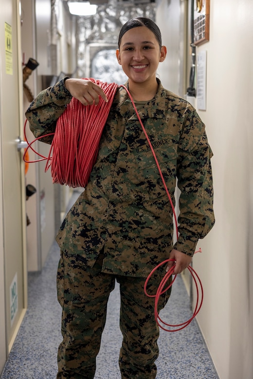 U.S. Marine Corps Sgt. Samantha Delgado, a network administrator with Marine Wing Communications Squadron (MWCS) 38, Marine Air Control Group 38, 3rd Marine Aircraft Wing, poses for a photo aboard the Independence-class littoral combat ship USS Savannah (LCS 28) at Naval Base San Diego, California, Dec. 6, 2023. Delgado supports Steel Knight 23.2 by building a network that sends traffic and data through a variety of systems, such as the AN/TPS-80 Ground/Air Task Oriented Radar. Steel Knight 23.2 is a three-phase exercise designed to train I MEF in the planning, deployment and command and control of a joint force against a peer or near-peer maneuver capabilities of the Marine Air-Ground Task Force. (U.S. Marine Corps photo by Sgt. Sean Potter)