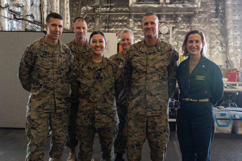 U.S. Marine Corps Sgt. Samantha Delgado, middle, a network administrator with Marine Wing Communications Squadron (MWCS) 38, Marine Air Control Group 38, 3rd Marine Aircraft Wing, poses for a photo with Marines and Sailors aboard the Independence-class littoral combat ship USS Savannah (LCS 28) at Naval Base San Diego, California, Dec. 6, 2023. Delgado supports Steel Knight 23.2 by building a network that sends traffic and data through a variety of systems, such as the AN/TPS-80 Ground/Air Task Oriented Radar. Steel Knight 23.2 is a three-phase exercise designed to train I MEF in the planning, deployment and command and control of a joint force against a peer or near-peer maneuver capabilities of the Marine Air-Ground Task Force. (U.S. Marine Corps photo by Sgt. Sean Potter)