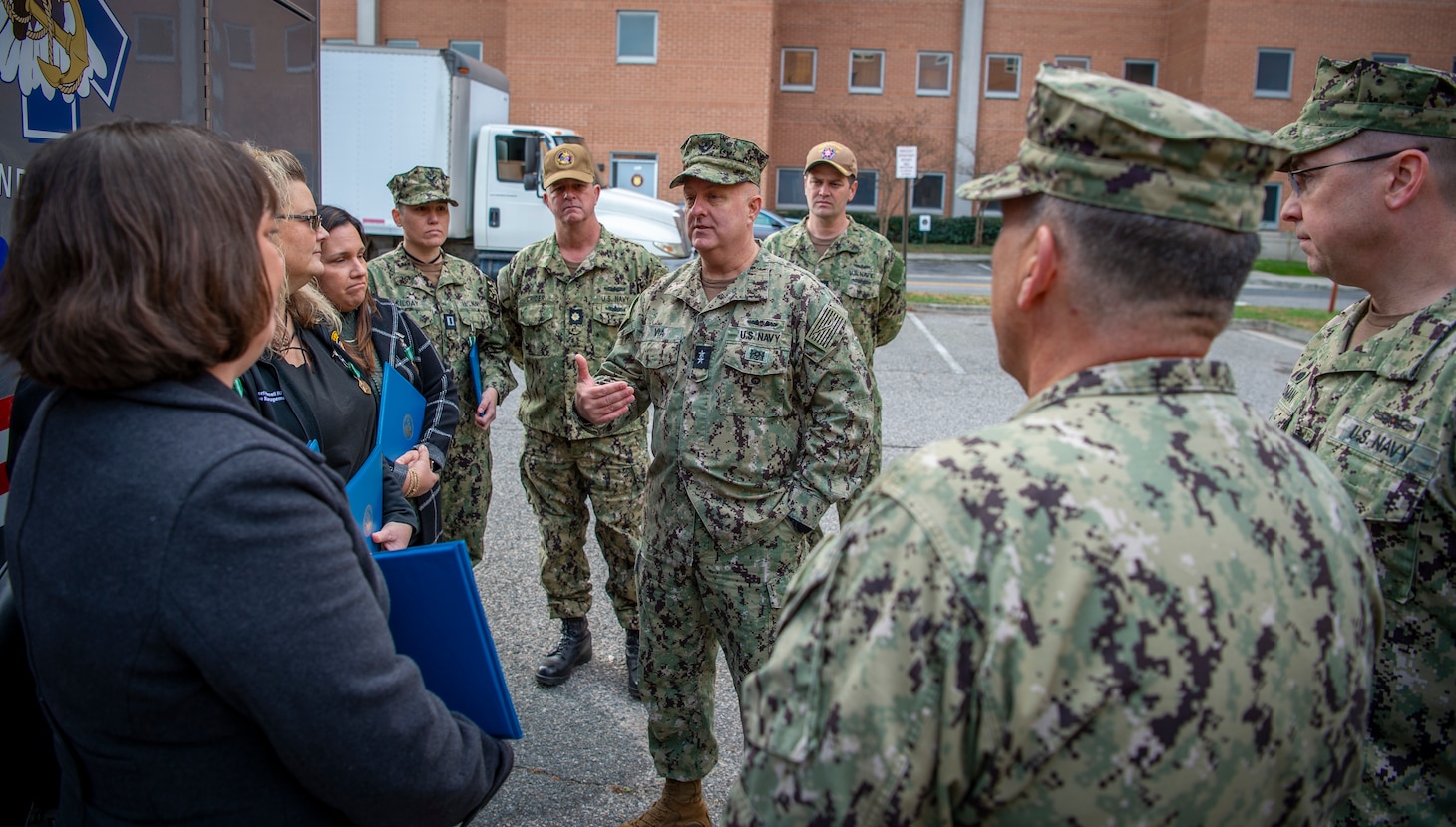 Surgeon General of the Navy Rear Adm. Darin Via, center, speaks with members from Naval Medical Center Portsmouth’s (NMCP) trauma team following a trauma center ribbon cutting ceremony in front of NMCP’s emergency room entrance on Dec. 8.