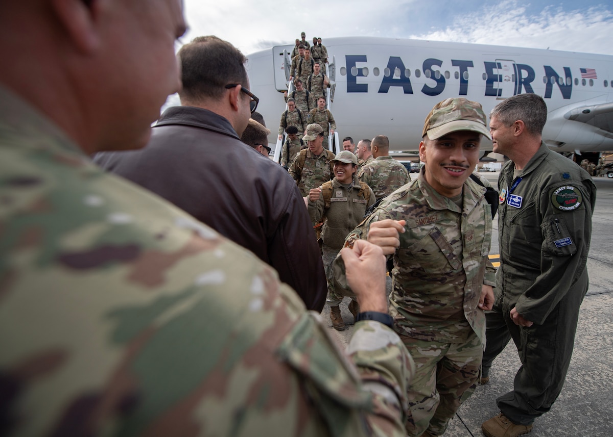 An Airman fist bumps another Airman