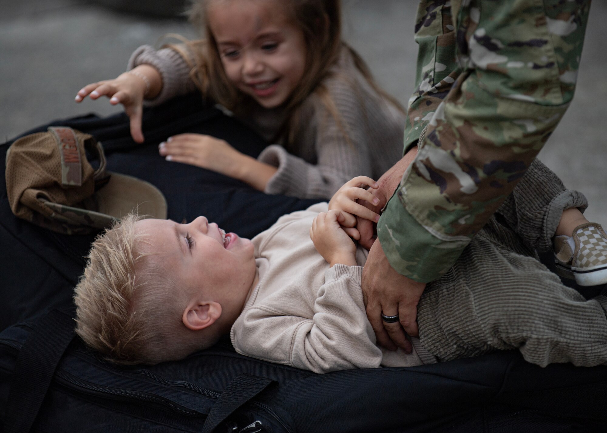 An Airman tickles his son