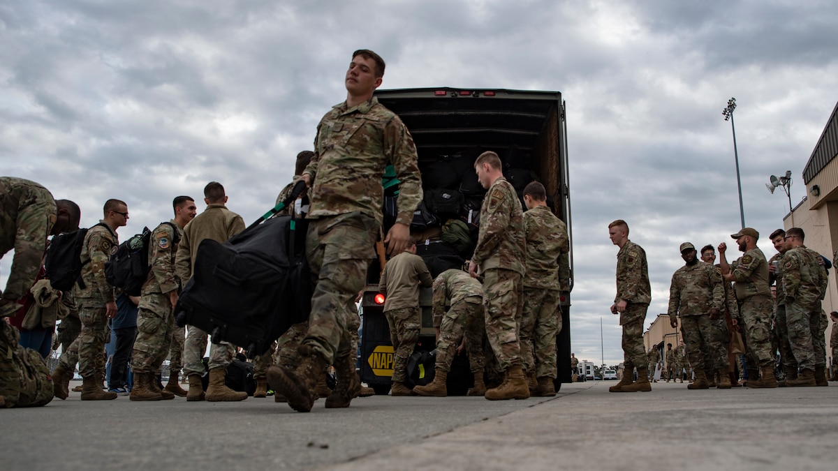 Airmen pick up their baggage