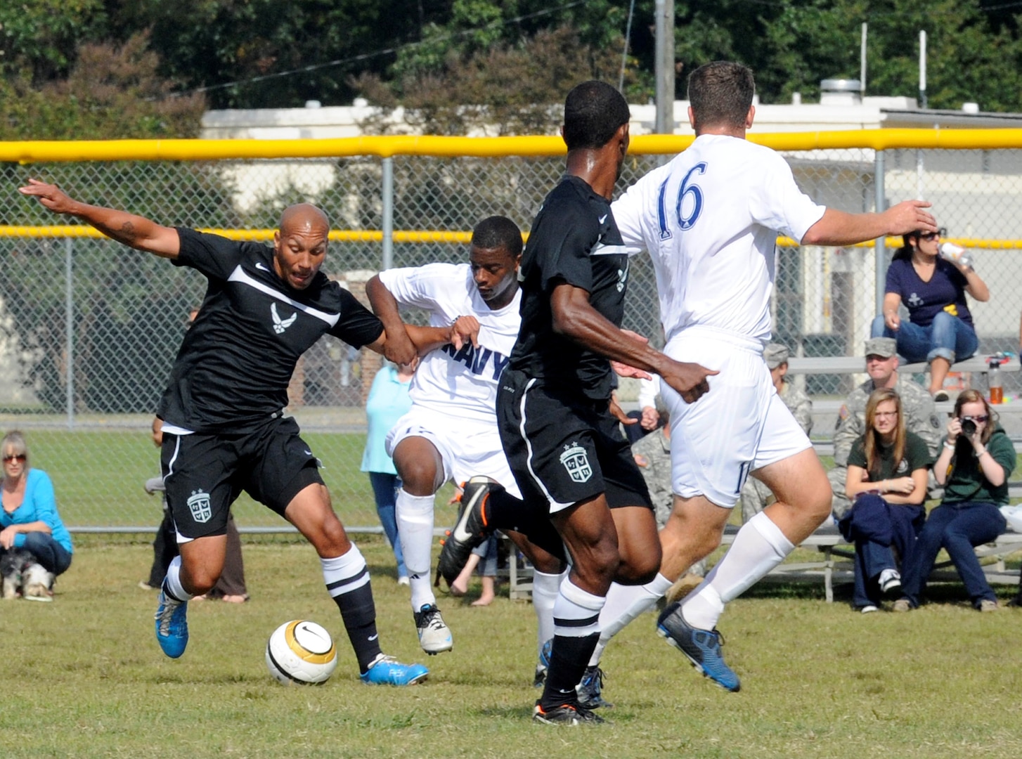 four players battle over the soccer ball