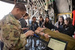 airmen demonstrate a patient simulator to children