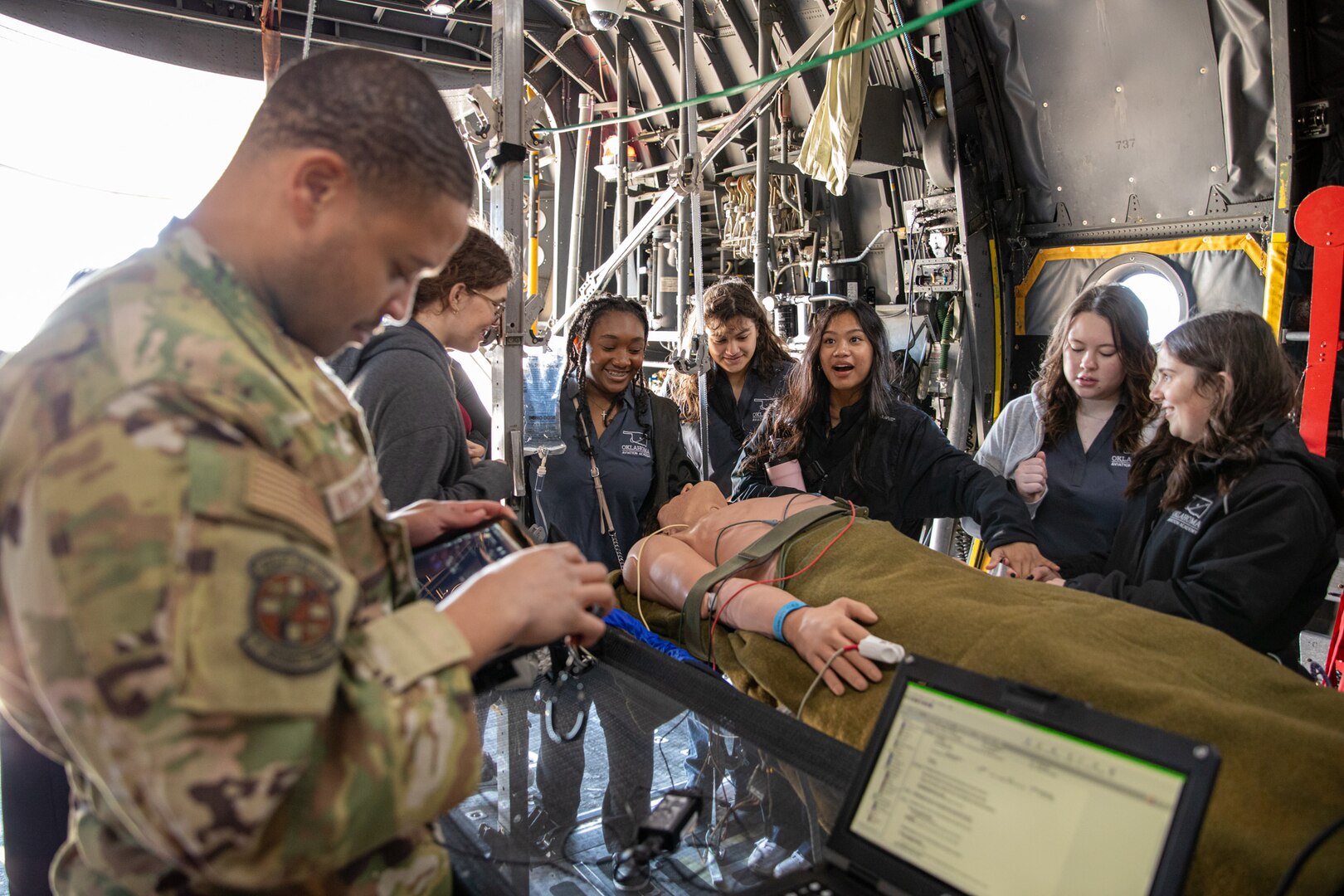 airmen demonstrate a patient simulator to children