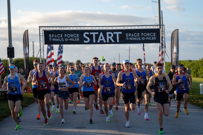 Participants cross the start line at the T-Minus 10-Miler at Cape Canaveral Space Force Station, Florida, Dec. 9, 2023. The T-Minus 10-Miler celebrates the Space Forces birthday. (U.S. Space Force photo by Senior Airman Samuel Becker)