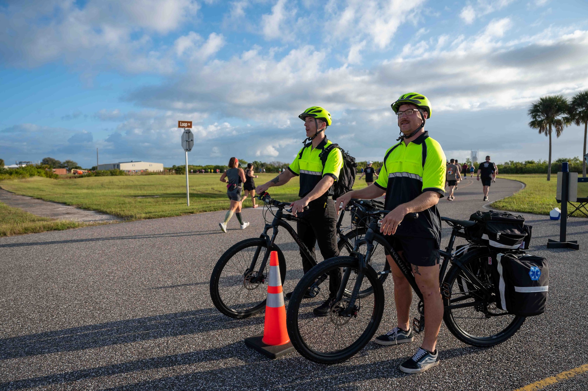 Bike Medics from the Patrick Space Force Base Fire Department monitor participants at the T-Minus 10-Miler at Cape Canaveral Space Force Station, Florida, Dec. 9, 2023. Bike Medics provide rapid response to those injured. (U.S. Space Force photo by Senior Airman Samuel Becker)