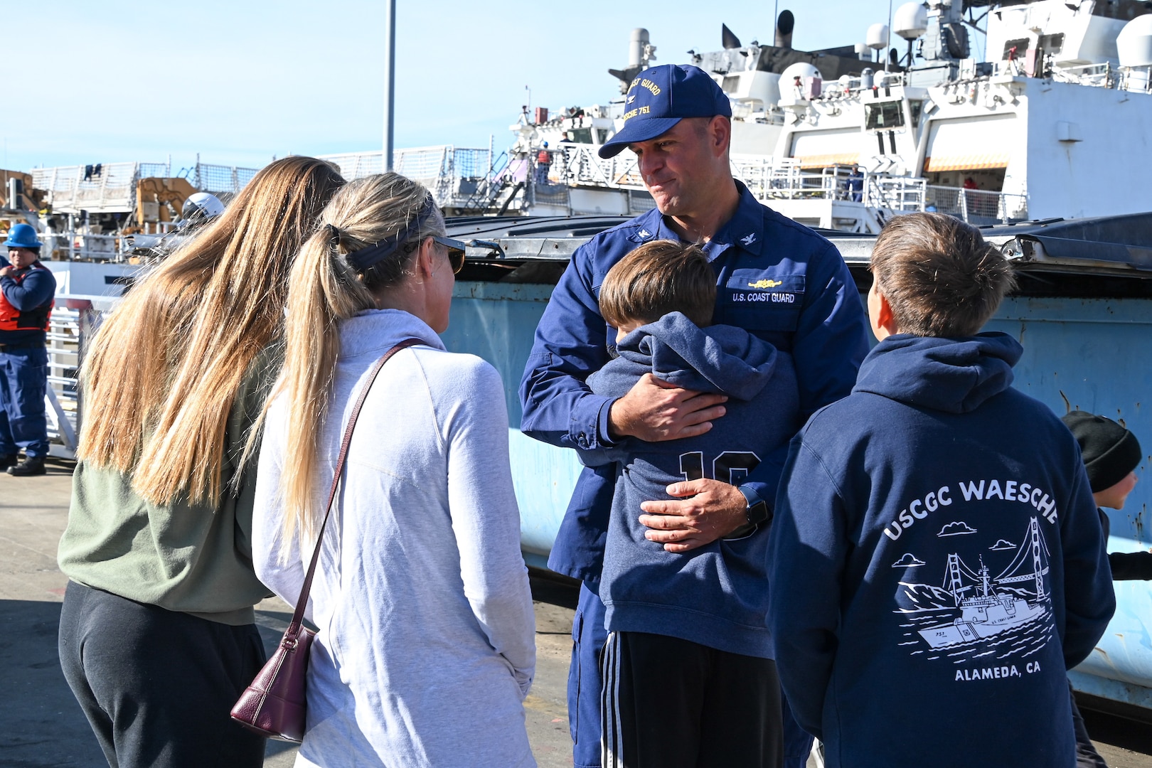 Family and friends celebrate as the U.S. Coast Guard Cutter Waesche (WMSL 751) crew returns to homeport in Alameda, Calif., Dec. 9, 2023. The Waesche and crew spent 89-days patrolling more than 19,740 miles in the Eastern Pacific Ocean conducting law enforcement and search and rescue operations in international waters off Central and South America. (U.S. Coast Guard photo by Senior Chief Petty Officer Charly Tautfest)