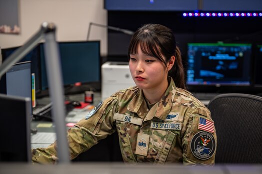  Space Force Sp4 Jacqueline Sul sits at work computer station.