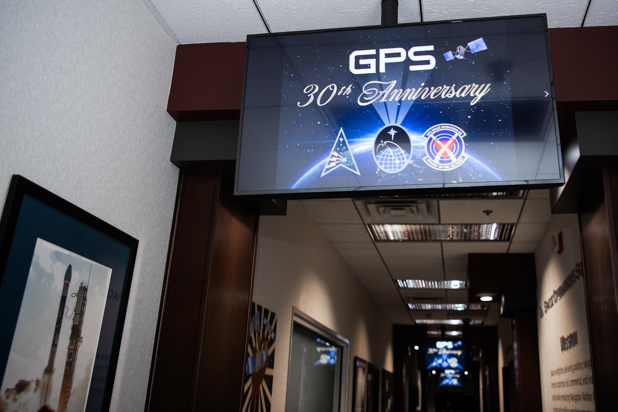 Television displaying GPS 30th Anniversary graphic.