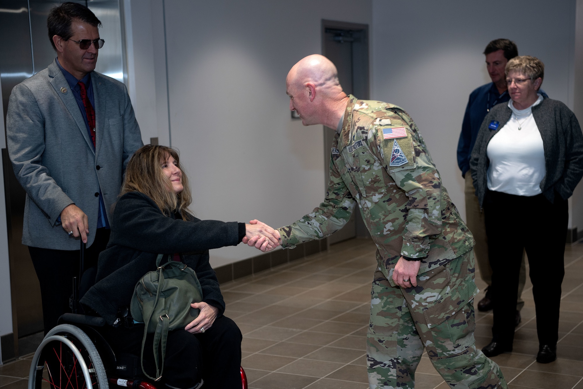 Ken DeGraaf and his wife Kim shake hands with Col. Andrew Menschner,