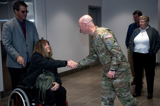  Ken DeGraaf and his wife Kim shake hands with Col. Andrew Menschner,