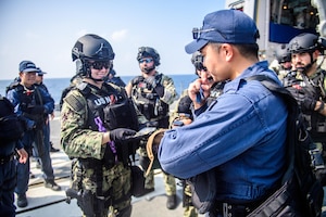 U.S. Navy Sailors from the guided-missile destroyer USS Mason (DDG 87) conduct bilateral training with Sailors from the Japanese Murasame-class destroyer Akebono (DD 108) in the Gulf of Aden, Nov. 25, 2023. Sailors from both ships trained on VBSS procedures, helicopter operations, and division tactic exercises, increasing interoperability between the two allies. As part of the Dwight D. Eisenhower Carrier Strike Group (IKECSG), the Mason is deployed to the U.S. 5th Fleet area of operations to support maritime security and stability in the Middle East. (U.S. Navy Photo by Mass Communication Specialist 3rd Class Samantha Alaman)