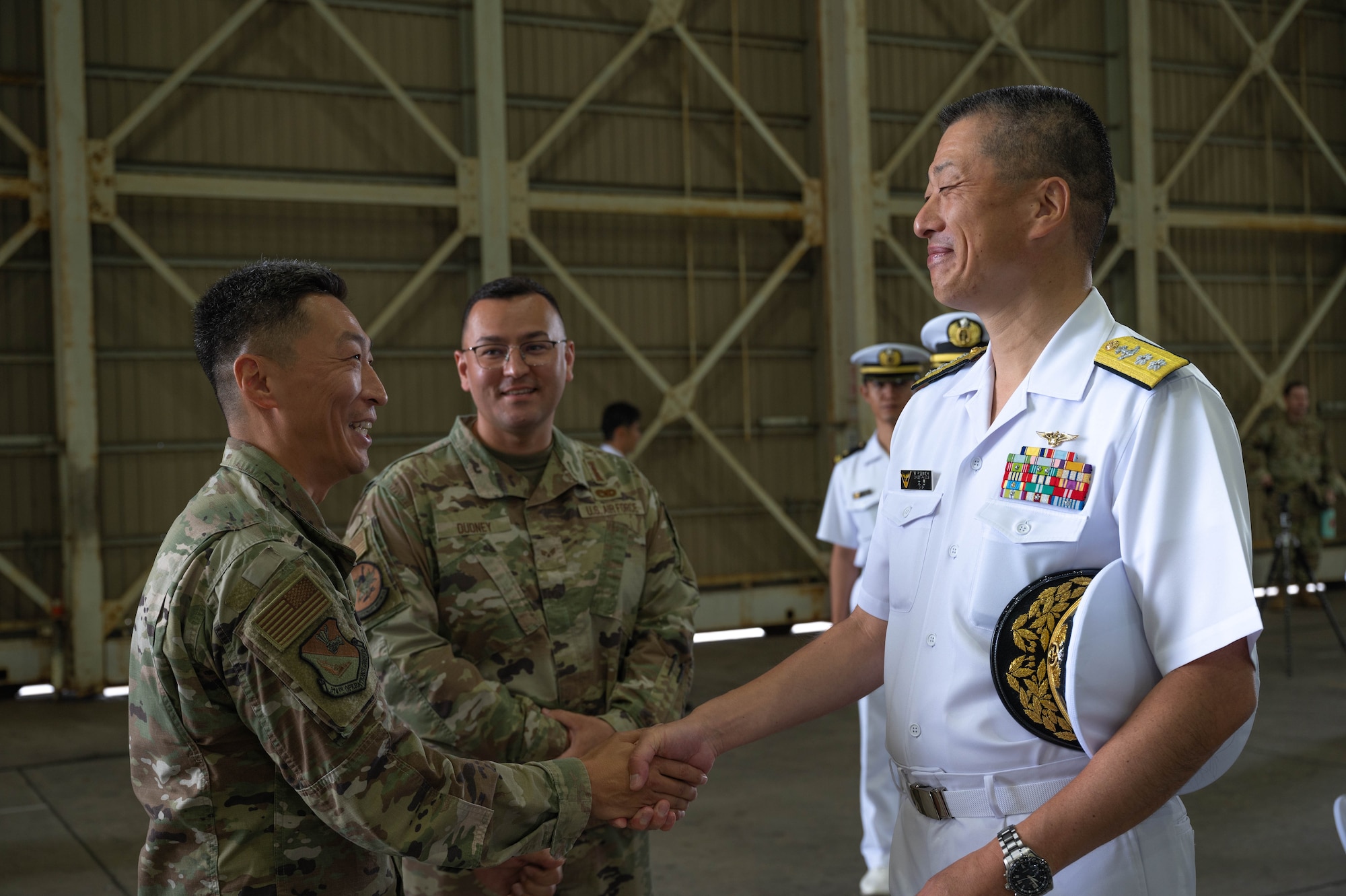 Colonel Jun Oh of the 374th Operation Group, speaks with Rear Admiral Onishi, Commander of fleet Air Wing 1, after the 319th Expeditionary Reconnaissance Squadron transition ceremony at Japan Maritime Self-Defense Force Kanoya Air Base, Oct. 13, 2023.