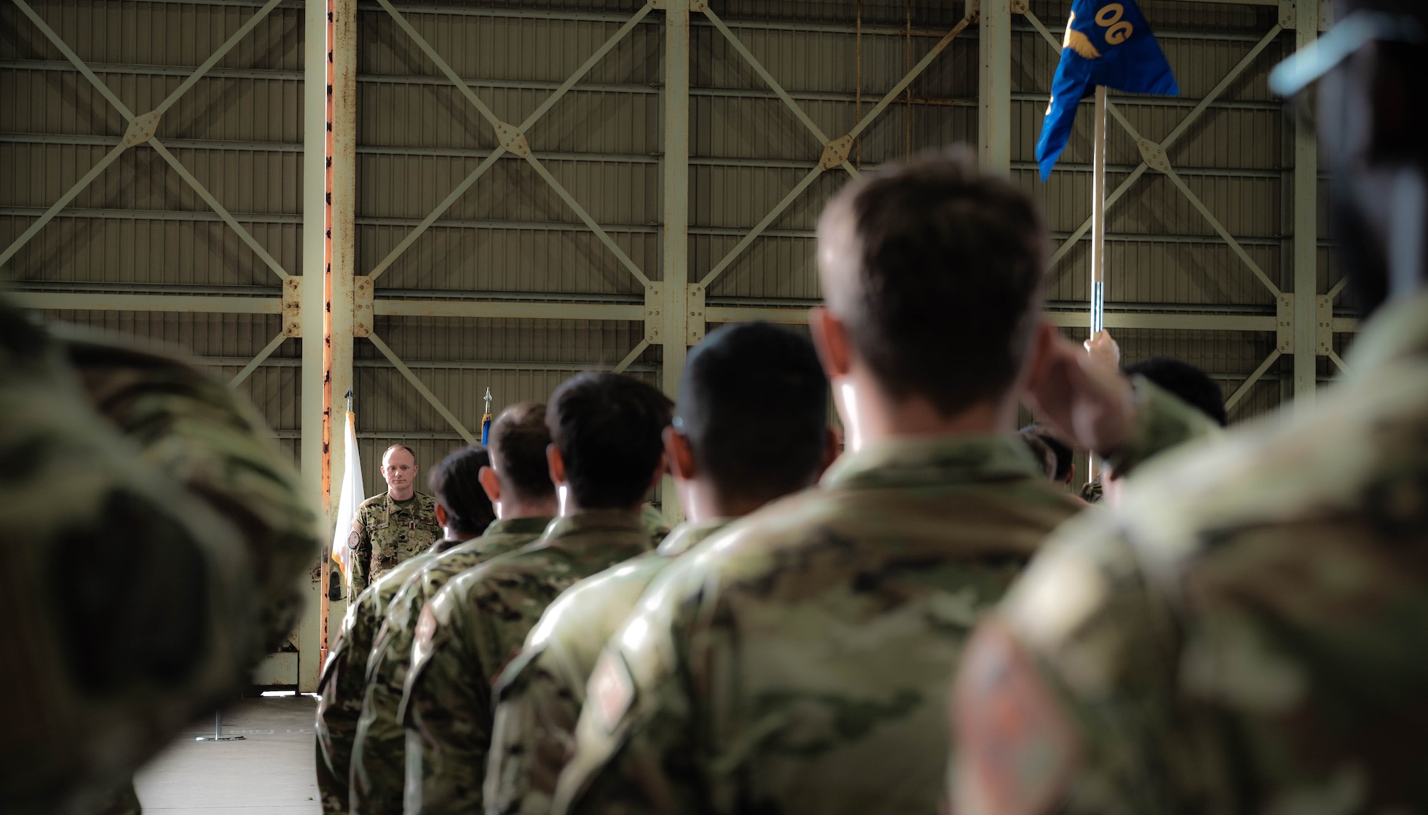 Lt. Col. Alexander Kelly, commanding officer of the 319th Expeditionary Reconnaissance Squadron receives a final salute from his squadron during the 319th ERS transition ceremony at Japan Maritime Self-Defense Force Kanoya Air Base, Oct. 13, 2023.