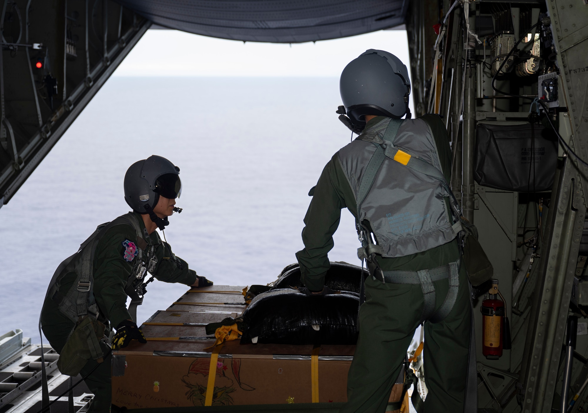 Members of the Japan Air Self-Defense Force 401st Tactical Airlift Squadron prepare a bundle of humanitarian aid for release in support of Operation Christmas Drop 2023 (OCD 23) above the Federated States of Micronesia, Dec. 6, 2023. OCD is the Department of Defense’s longest-running humanitarian airlift operation which consists of packaging and delivering donated supplies such as food, fishing equipment, school books and clothing to more than 20,000 islanders across 58 remote islands throughout the Pacific. (U.S. Air Force photo by Airman 1st Class Spencer Perkins)