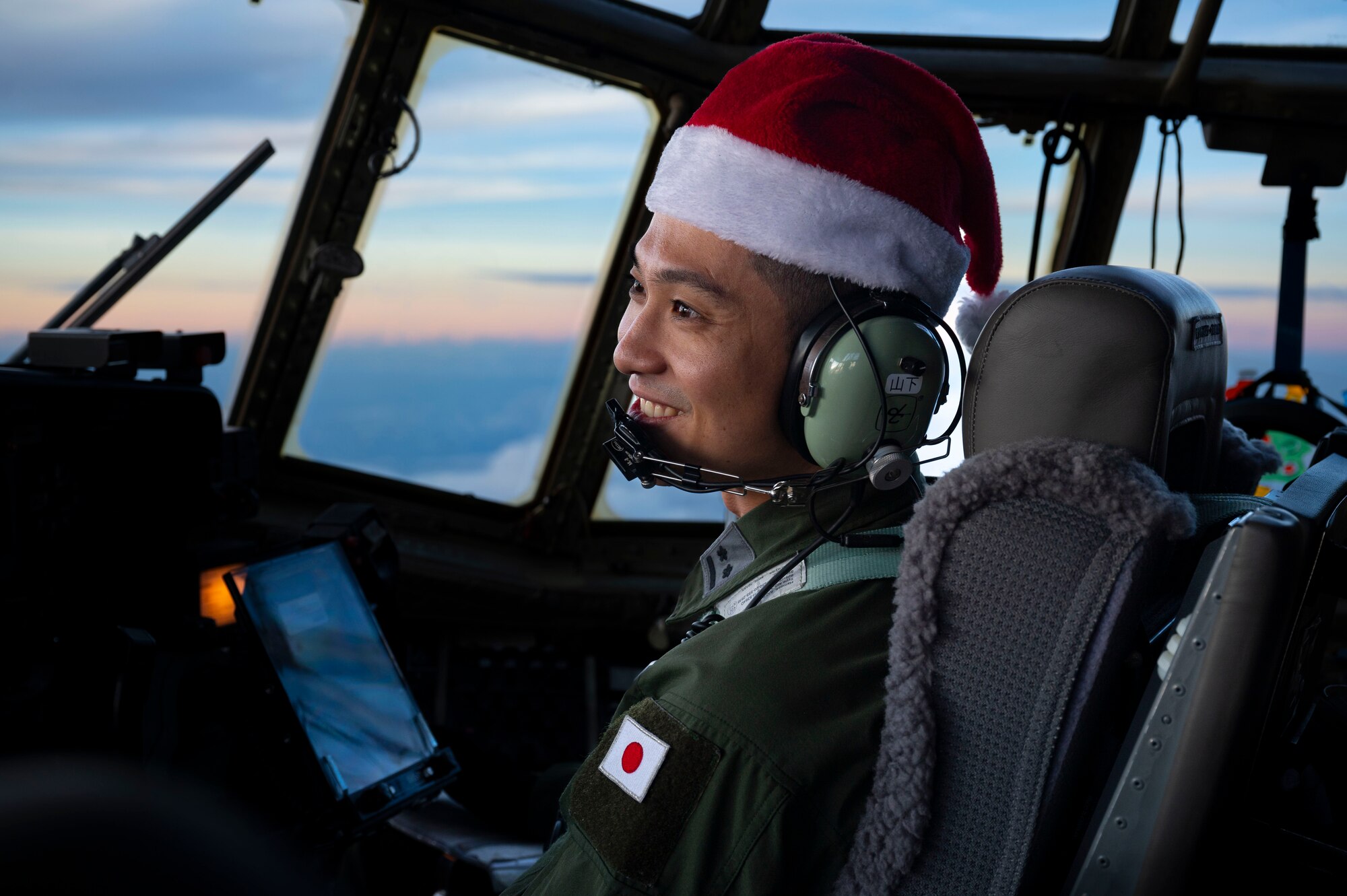 Japan Air Self-Defense Force (JASDF) 1st Lt. Shuhei Yamashita, 401st Tactical Airlift Squadron pilot, flies a JASDF C-130H Hercules during Operation Christmas Drop 2023 (OCD 23) above the Federated States of Micronesia, Dec. 6, 2023. Operation Christmas Drop is the Department of Defense’s longest-running humanitarian airlift operation which consists of packaging and delivering donated supplies such as food, fishing equipment, school books and clothing to more than 20,000 islanders across 58 remote islands throughout the Pacific. (U.S. Air Force photo by Airman 1st Class Spencer Perkins)