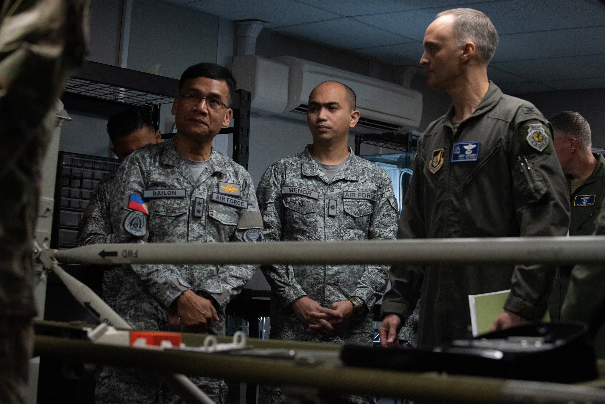 military members stand in front of a innovation lab table