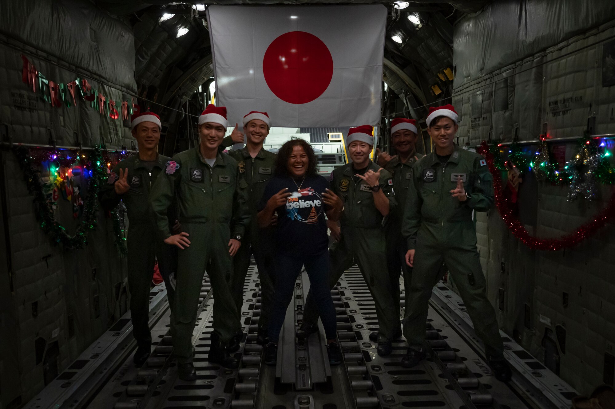 Nanako Lipai, a Mokil Atoll native, and members of the Japan Air Self-Defense Force pose for a photo after a flight in support of Operation Christmas Drop 2023 (OCD 23), at Andersen Air Force Base, Guam, Dec. 6, 2023. This was Lipai’s third time flying during OCD but it was the first time she got to fly to her home island to drop supply bundles. Through the international cooperation and the enduring commitment of the U.S. Air Force and its allies and partners, OCD has become a testament to the power of collaboration and shared humanity. (U.S. Air Force photo by Airman 1st Class Spencer Perkins)