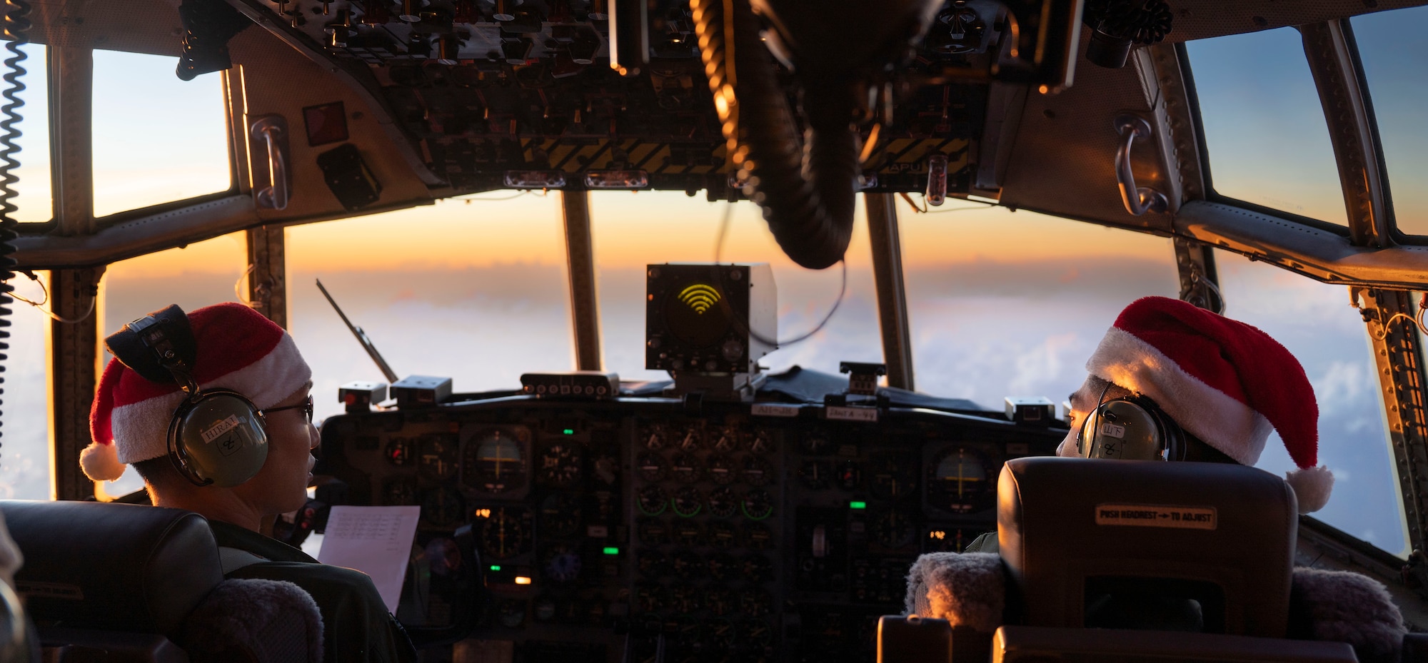 (Left to right) Japan Air Self-Defense Force (JASDF) Maj. Kentaro Hirai and 1st Lt. Shuhei Yamashita, 401st Tactical Airlift Squadron pilots, talk while piloting a JASDF C-130H Hercules during Operation Christmas Drop 2023 (OCD 23) above the Federated States of Micronesia, Dec. 6, 2023. OCD is the Department of Defense’s longest-running humanitarian airlift operation which consists of packaging and delivering donated supplies such as food, fishing equipment, school books and clothing to more than 20,000 islanders across 58 remote islands throughout the Pacific. (U.S. Air Force photo by Airman 1st Class Spencer Perkins)