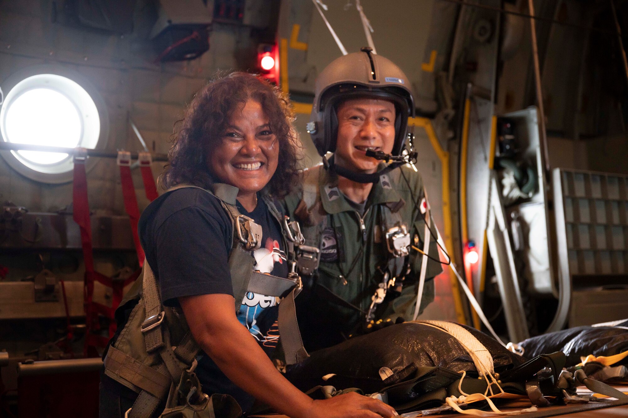 (Left to right) Nanako Lipai, a Mokil Atoll native, and Japan Air Self-Defense Force Master Sgt. Kazunari Yamamoto, 401st Tactical Airlift Squadron loadmaster, pose for a photo during a flight for Operation Christmas Drop 2023 (OCD 23) above the Federated States of Micronesia, Dec. 6, 2023. This was Lipai’s third time flying during OCD but it was the first time she got to fly to her home island to drop supply bundles. Through the international cooperation and the enduring commitment of the U.S. Air Force and its allies and partners, OCD has become a testament to the power of collaboration and shared humanity. (U.S. Air Force photo by Airman 1st Class Spencer Perkins)