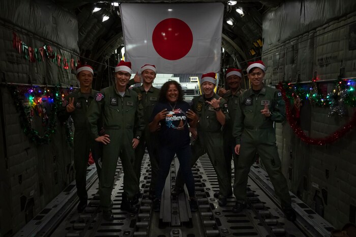 Nanako Lipai, a Mokil Atoll native, and members of the Japan Air Self-Defense Force pose for a photo after a flight in support of Operation Christmas Drop 2023 (OCD 23), at Andersen Air Force Base, Guam, Dec. 6, 2023. This was Lipai’s third time flying during OCD but it was the first time she got to fly to her home island to drop supply bundles. Through the international cooperation and the enduring commitment of the U.S. Air Force and its allies and partners, OCD has become a testament to the power of collaboration and shared humanity. (U.S. Air Force photo by Airman 1st Class Spencer Perkins)