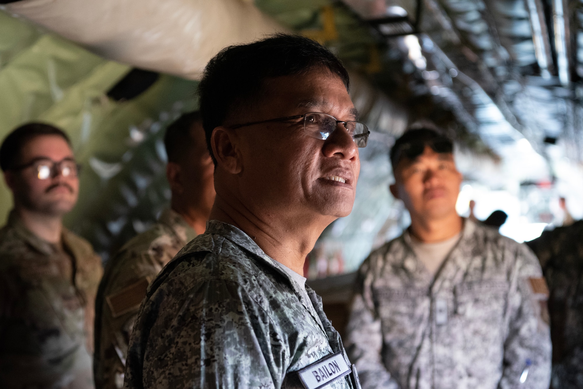 military member looks at the inside of a plane