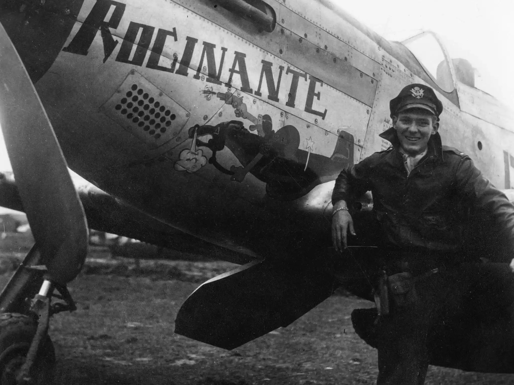 Pilot stands next to his aircraft.
