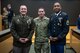 Three male U.S. Army soldiers pose for a photo after an award ceremony.