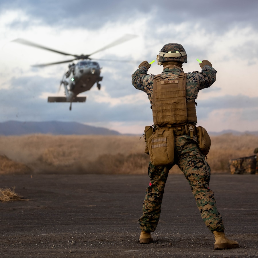 U.S. Marine Corps Lance Cpl. Graham Stratton, a landing support specialist, with Combat Logistics Battalion 4, Combat Logistics Regiment 3, 3rd Logistics Group, ground guides an inbound MH-60S for a “Just-In-Time” logistical resupply during Stand-in Force Exercise 24 at the Eastern Fuji Maneuver Area on Combined Arms Training Center Camp Fuji, Dec. 4, 2023. CLB-4 facilitated a resupply to 2nd Battalion, 7th Marine Regiment, as a proof of concept for a multi-domain corridor that enables "Just-in-Time" logistics. SIFEX 24 is a division-level exercise involving all elements of the Marine Air-Ground Task Force focused on strengthening multi-domain awareness, maneuver, and fires across a distributed maritime environment. This exercise serves as a rehearsal for rapidly projecting combat power in defense of allies and partners in the region.