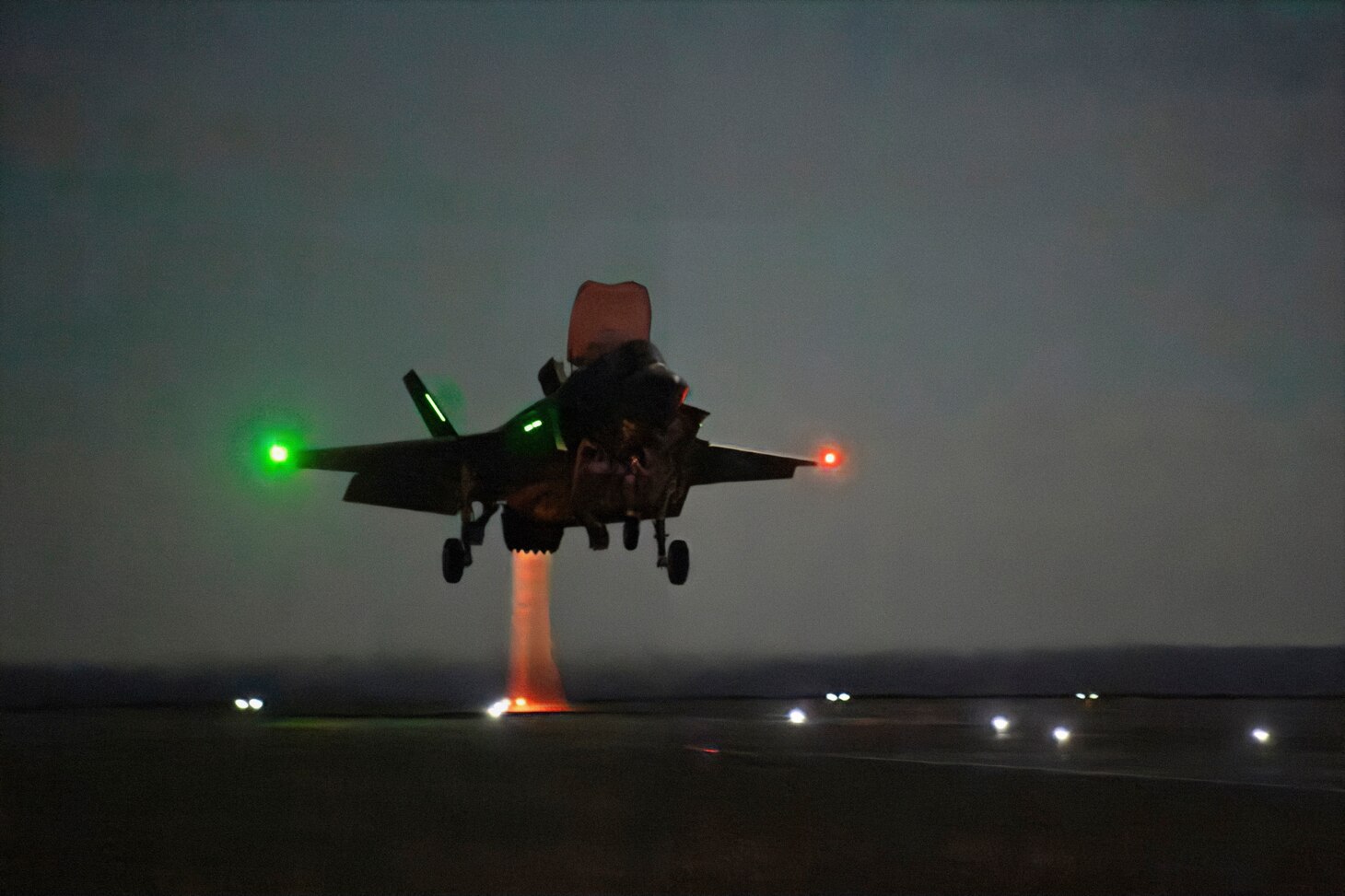 U.S. Marine Corps test pilot Maj. Paul Gucwa performs a vertical landing (VL) in an F-35B Lightning II short takeoff vertical landing (STOVL) variant strike fighter during a mission to expand the flight envelope for the technique aboard the U.K. aircraft carrier HMS Prince of Wales (R09) Oct. 29, 2023. Gucwa also performed the first night shipborne rolling VL (SRVL) during the evening’s flight period. Gucwa is one of three test pilots from embarked with a broader team from the Patuxent River F-35 Integrated Test Force (PAX ITF) to conduct flight test during the ongoing developmental test phase 3 (DT-3) flight trials. HMS Prince of Wales, the U.K.’s newest aircraft carrier and biggest warship, is deployed to the Western Atlantic for WESTLANT 23.