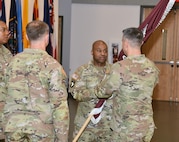 Sgt. Maj. Akram Shaheed passes the Army Medical Logistics Command unit colors to Commander Col. Marc Welde during a change of responsibility ceremony Dec. 8, 2023, at Fort Detrick, Maryland. Shaheed turned over his role as senior enlisted leader to Command Sgt. Maj. Gabriel Wright. (C.J. Lovelace)