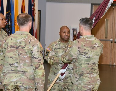 Sgt. Maj. Akram Shaheed passes the Army Medical Logistics Command unit colors to Commander Col. Marc Welde during a change of responsibility ceremony Dec. 8, 2023, at Fort Detrick, Maryland. Shaheed turned over his role as senior enlisted leader to Command Sgt. Maj. Gabriel Wright. (C.J. Lovelace)