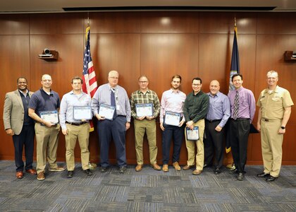 Naval Surface Warfare Center, Philadelphia Division (NSWCPD) Commanding Officer Capt. Joseph Darcy and NSWCPD Technical Director Nigel C. Thijs, SES, present the Naval Sea Systems Command (NAVSEA) Warfare Center Technical Support Service Award to the Coast Guard Machinery Control Systems Team. Team members included (from left to right): Tim Sipe, George Reick, Jim Covert, Jim Mcclain, Zach Bean, Nick Stumpo, Walt McDonald, and Steve Berry. NSWCPD honored employees during its Fiscal Year (FY) 2023 Fourth Quarter Awards Ceremony on Nov. 28, 2023. (U.S. Navy Photo by Phil Scaringi/Released)