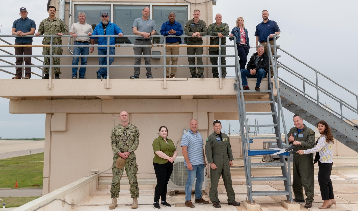 Members of the Airborne Strategic Command, Control and Communications Program Office, Strategic Communications Wing One (SCW-1), L3Harris, the Air Force Nuclear Weapons Center and the “Take Charge and Move Out” (TACAMO) Weapons School participate in a ribbon-cutting for new communications equipment at Tinker Air Force Base, Oklahoma, on May 3. At bottom right, SCW-1 Deputy for Communications Lt. Cdr. Paul Brazier and Laura Young, then-Integrated Product Team Lead for Wideband Systems, cut the ribbon.