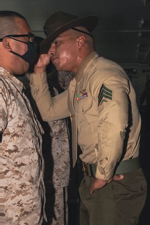 U.S. Marine Corps Sgt. Rafael Jr. Garcia, drill instructor with India Company, 3rd Recruit Training Battalion, gives instructions during pick up at Marine Corps Recruit Depot, San Diego, Dec. 1, 2023. Recruits were introduced to their drill instructors, where they gained an understanding of the rules and expectations set for their training. Garcia is native of Lubbock, Texas. (U.S. Marine Corps photo by Lance Cpl. Janell B. Alvarez)