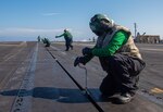 Aircraft Launch and Recovery Equipment (ALRE) Sailors man an arresting gear wire on the flight deck of USS Harry S. Truman (CVN 75) during a scheduled deployment.