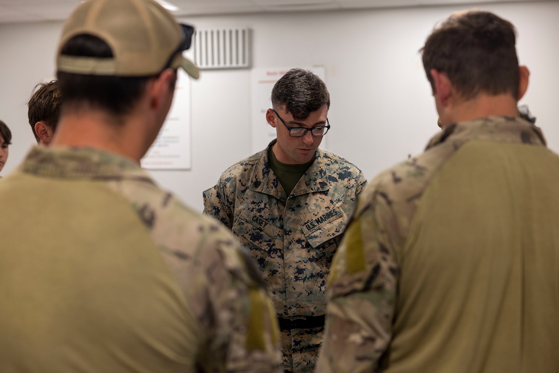 U.S. Marine Corps Sgt. Dustin Casey, a squad leader with Battalion Landing Team 1/8, works through a mission plan for a joint raid with critical skills operators from Marine Forces Special Operations Command during an integration training event on Camp Lejeune, North Carolina, Nov. 21, 2023. MARSOC worked with Marines from BLT 1/8 to increase interoperability with the Fleet Marine Force. (U.S. Marine Corps photo by Cpl. Henry Rodriguez)